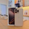 Desert titanium iPhone 16 Pro Max standing next to its box - Legacy Luxury Store Ghana