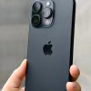 Black titanium iPhone 16 Pro in hand - Legacy Luxury Store Ghana