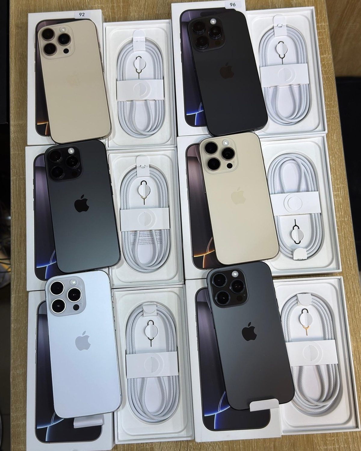 iPhone 16 Pro titanium colours fan in hand - Legacy Luxury Store Ghana